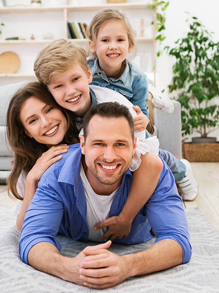 Family of four playing in living room
