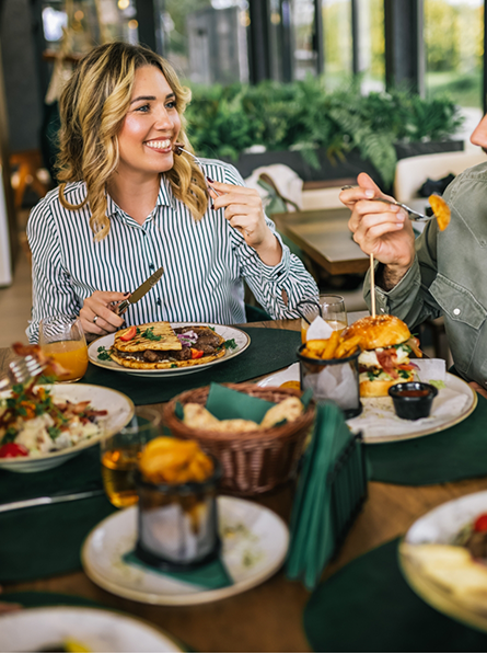 Woman enjoying meal with family at dinner table