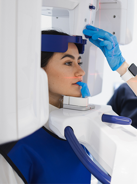 Woman having teeth scanned with cone beam scanner