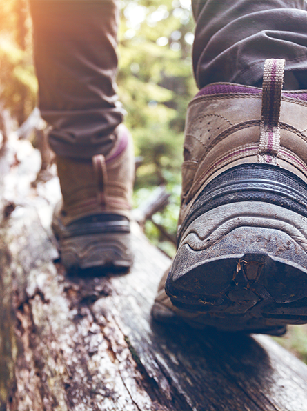 Close up of boots walking on log