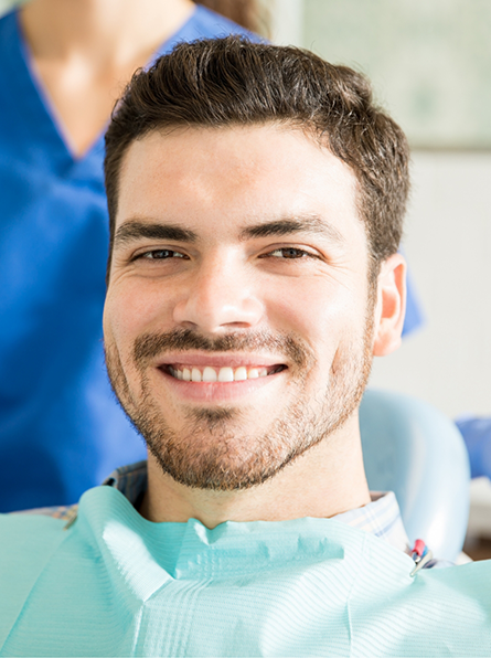 Bearded man in dental chair smiling