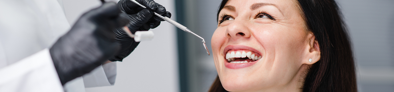 Female patient having her teeth examined