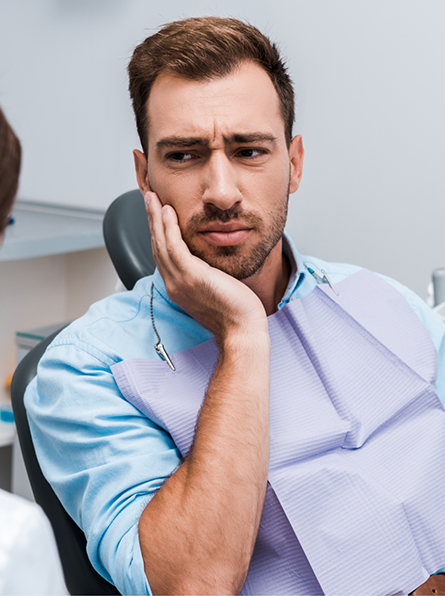 Male patient with toothache visiting dentist