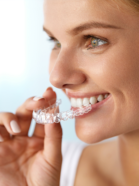 Woman putting in clear aligner